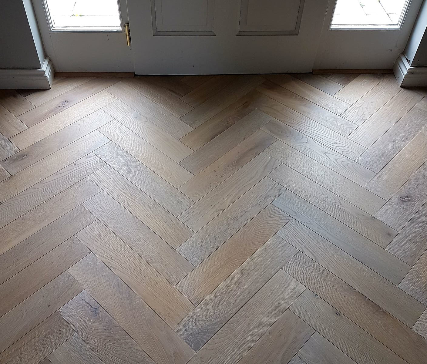Herringbone solid wood flooring in an entrance hall of a house